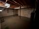Unfinished basement with concrete floors and exposed ceiling at 80 Brooks Ln, Dallas, GA 30157