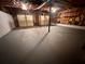 Unfinished basement area featuring concrete flooring, dual garage doors and exposed utilities at 80 Brooks Ln, Dallas, GA 30157