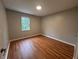 Bright bedroom showcasing wood floors, a window, and a neutral color palette at 80 Brooks Ln, Dallas, GA 30157