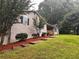 Charming home with landscaped yard and stone steps leading to the entrance at 80 Brooks Ln, Dallas, GA 30157