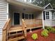 Covered front porch of home with wooden deck and railing at 80 Brooks Ln, Dallas, GA 30157