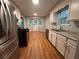 Well-lit kitchen featuring stainless steel appliances, granite countertops, and wood flooring at 80 Brooks Ln, Dallas, GA 30157