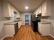 Modern kitchen with stainless steel appliances, stone countertops and wood-style floors at 80 Brooks Ln, Dallas, GA 30157