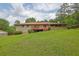 View of the home's exterior featuring a sprawling backyard with mature trees and a deck at 2149 New London Place Pl, Snellville, GA 30078
