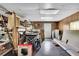 Unfinished basement with wood paneling, a drop ceiling, and a variety of stored items and equipment at 2149 New London Place Pl, Snellville, GA 30078