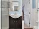 Bathroom featuring a dark vanity with a vessel sink, a framed mirror, and a shower with glass doors at 2149 New London Place Pl, Snellville, GA 30078