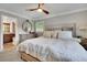 Serene bedroom with plush bedding, a ceiling fan, and soft natural light at 2149 New London Place Pl, Snellville, GA 30078