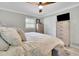 Comfortable bedroom with a ceiling fan, and ample storage from the chest of drawers and closet at 2149 New London Place Pl, Snellville, GA 30078