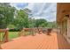 Spacious outdoor deck with dining furniture is perfect for enjoying the backyard view at 2149 New London Place Pl, Snellville, GA 30078