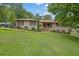 Beautiful brick ranch home with manicured lawn and landscaping; pickup truck parked in driveway at 2149 New London Place Pl, Snellville, GA 30078