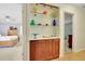 Hallway view of a built-in hutch with glass shelves and wooden doors, connecting two bedrooms at 2149 New London Place Pl, Snellville, GA 30078