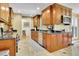 Modern kitchen with custom cabinetry, black countertops, stainless steel appliances, and tile floors at 2149 New London Place Pl, Snellville, GA 30078