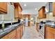 Well lit kitchen featuring stainless steel appliances, wood cabinets, and granite countertops at 2149 New London Place Pl, Snellville, GA 30078