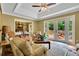 Bright living room with tray ceiling, glass doors to deck, and open view to dining area at 2149 New London Place Pl, Snellville, GA 30078