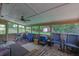 Screened-in porch with ceiling fan, outdoor furniture, and a view of the wooded backyard and a shed at 2149 New London Place Pl, Snellville, GA 30078