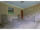 Covered front porch with brick accent wall, neutral siding, and metal chairs and a glass table at 2149 New London Place Pl, Snellville, GA 30078
