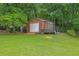 A utility shed in a well-maintained yard provides ample outdoor storage space at 2149 New London Place Pl, Snellville, GA 30078