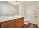 Bright bathroom featuring wood cabinets, vanity, and a shower-tub combination at 234 Riverstone Commons Cir, Canton, GA 30114