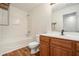 Bathroom with a wooden vanity, toilet, and combined shower and tub at 234 Riverstone Commons Cir, Canton, GA 30114