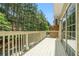 A light-colored deck overlooks lush greenery and trees at 234 Riverstone Commons Cir, Canton, GA 30114