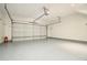A spacious, well-lit garage features a sealed concrete floor and white door at 234 Riverstone Commons Cir, Canton, GA 30114