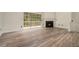 Spacious living room showcasing new floors, a fireplace, and sliding doors to a patio at 234 Riverstone Commons Cir, Canton, GA 30114