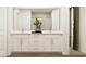 Elegant bathroom vanity with double sinks, white cabinetry, and modern fixtures at 2464 Cotton Ln, Douglasville, GA 30135