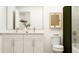 Well-lit bathroom featuring dual sink vanity, framed mirror, elegant fixtures and neutral wall art at 2464 Cotton Ln, Douglasville, GA 30135