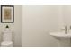 Clean, simple half-bathroom features a pedestal sink, and decor touches at 2464 Cotton Ln, Douglasville, GA 30135