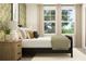 Cozy bedroom with decorative wallpaper, comfortable bed, and ample natural light from the large windows at 2464 Cotton Ln, Douglasville, GA 30135