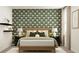 Inviting bedroom featuring a decorative wall, bedside tables with lamps, and a comfortable, well-styled bed at 2464 Cotton Ln, Douglasville, GA 30135