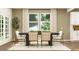 Elegant dining room boasting a modern dining set, large windows, and stylish decor for Gathering gatherings at 2464 Cotton Ln, Douglasville, GA 30135