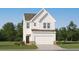 Charming two-story white home with a well-manicured lawn, integrated garage and a classic architectural design at 2464 Cotton Ln, Douglasville, GA 30135