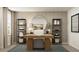 Bright home office featuring a modern desk, stylish decor, and ample shelving for storage and display at 2464 Cotton Ln, Douglasville, GA 30135