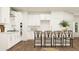 Modern white kitchen featuring stainless steel appliances, sleek cabinetry, subway tile backsplash, and island seating at 2464 Cotton Ln, Douglasville, GA 30135