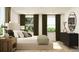 Stylish bedroom featuring a king-sized bed, dark wood accents, natural light, and tasteful decor at 2464 Cotton Ln, Douglasville, GA 30135