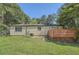 The back of the house includes a wooden deck and a large grassy yard with mature trees at 2948 Sagewood Dr, Snellville, GA 30039