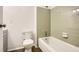 Bathroom with retro, sage-green tiled shower-tub and a white toilet at 2948 Sagewood Dr, Snellville, GA 30039