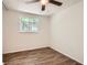This bedroom features a ceiling fan, wood-look flooring, and a window for natural light at 2948 Sagewood Dr, Snellville, GA 30039