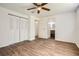 Bedroom with hardwood flooring, a ceiling fan, and access to a well-lit bathroom and ample closet space at 2948 Sagewood Dr, Snellville, GA 30039