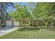 Inviting single-story home featuring a brick facade, attached two-car garage, and manicured lawn with mature trees at 2948 Sagewood Dr, Snellville, GA 30039