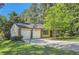 Charming brick and siding home with attached two-car garage and a basketball hoop in the driveway at 2948 Sagewood Dr, Snellville, GA 30039