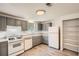Well-equipped kitchen with gray cabinets, gas range, granite countertops and stainless steel appliances at 2948 Sagewood Dr, Snellville, GA 30039