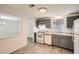 A kitchen with wood floors, white appliances and gray cabinets offers a clean and modern design at 2948 Sagewood Dr, Snellville, GA 30039