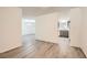 Bright living room showcasing wood floors and seamless flow into kitchen with gray cabinets at 2948 Sagewood Dr, Snellville, GA 30039