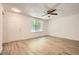 Spacious living room with wood floors, ceiling fan, large window, and white painted walls at 2948 Sagewood Dr, Snellville, GA 30039