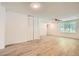 Well-lit living room with wood floors, new paint, closet and view of the entry door and window at 2948 Sagewood Dr, Snellville, GA 30039