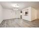 Open-concept living room with white walls and hardwood flooring, leading into a kitchen area with neutral cabinets at 2948 Sagewood Dr, Snellville, GA 30039