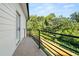 Balcony view with black metal railing overlooking the surrounding lush trees and backyard at 327 Ohm Ave, Avondale Estates, GA 30002