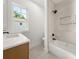 Bright bathroom featuring a modern vanity with a quartz countertop and a shower-tub combo at 327 Ohm Ave, Avondale Estates, GA 30002